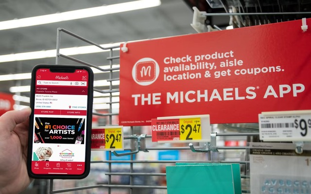 A person using the Michaels app to find coupons