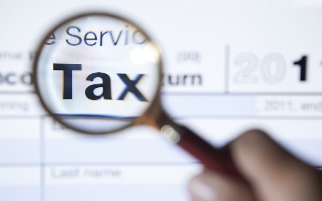 Magnifying glass finding hidden tax deductions