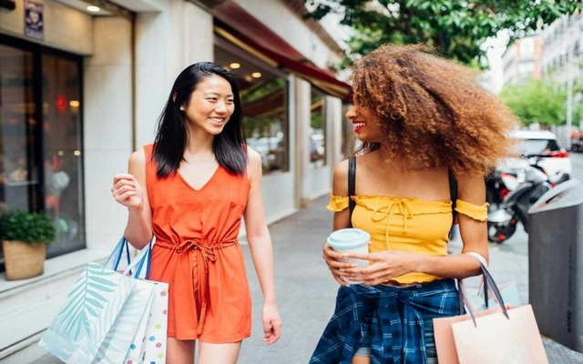 Person leaving American Eagle store with a smile and a shopping bag