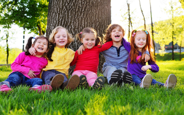 Smiling children wearing colorful outfits from The Children's Place.