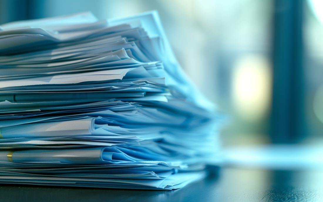 A stack of financial documents with the Staples logo, symbolizing the company's exchange offer for outstanding notes